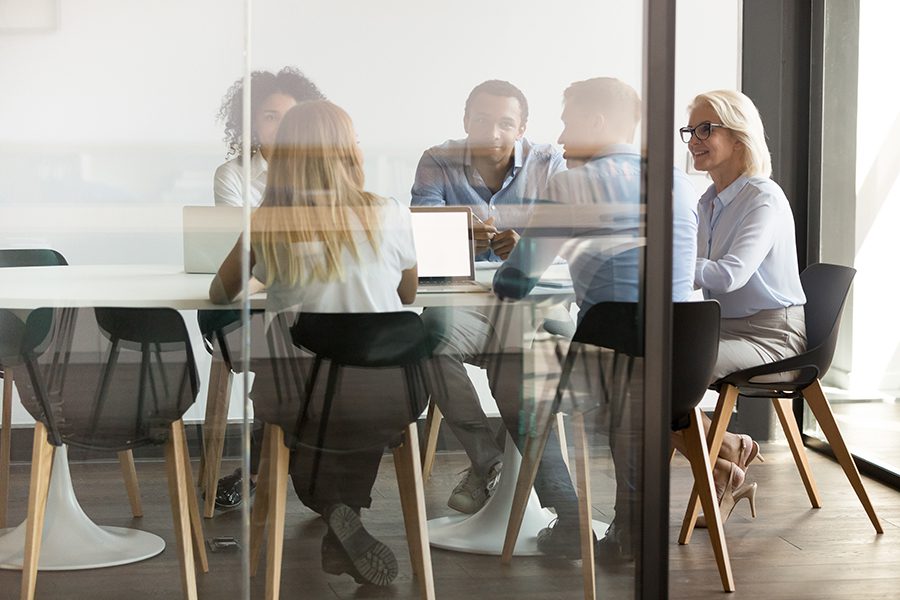 About Our Agency - Employees and Partners of Harrison Agency, Inc. Brainstorm and Discuss Ideas Together in the Company Boardroom